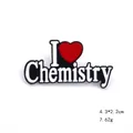 Detail shot of I Heart Chemistry enamel brooch pin with black finish and red heart icon - Chemistry Style