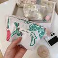 Close-up of floral embroidery on a mini canvas pouch with a secure zipper closure - Rose Red Flower