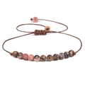 Detailed macro of 4mm natural stone beads with adjustable brown braided cord closure - Pink Brown Rhodonite/FD8443