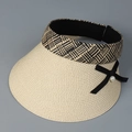 Detail of woven straw sun visor featuring black ribbon bow and elegant pearl accent - M (56-58cm) / Beige