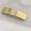Rectangular golden metal hair clip with a minimalist brushed texture and curved design - Square Striped Gold