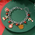 Detailed shot of Christmas charm bracelet with bells and snowflakes on a green tray - D1245 (Silver Chain Multi-element)