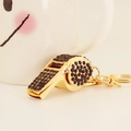 Golden metal whistle keychain with black rhinestones and a polished link chain - Black