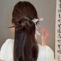 Elegant purple flower hairpin with pearl tassels shown on a traditional hairstyle - Hairpin #158 - Purple