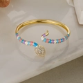 Detailed close-up of golden snake bracelet with colorful enamel and sparkling zircons - Multi-color Enamel (31223)