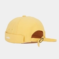 Detail of yellow canvas brimless docker cap showing adjustable metal buckle and fish embroidery - Yellow