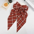 Red and black plaid bow hair clip with long ribbons on a minimalist white tray - Red Plaid