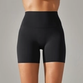 Detail of high-waist black yoga shorts showing double-sided brushed fabric and seamless stitching - Black