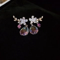 Detail of flower stud earrings with sparkling purple teardrop crystals and gold finish - Gold-Purple-Flower