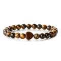Natural tiger eye beaded bracelet with heart shaped stone on white background - Tiger's Eye Style