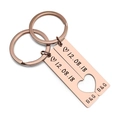 Close-up of rose gold rectangular couple keychains with a heart cutout and custom date - Rose Gold (1 Pair)