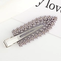 Detail of silver hair clip with purple pearls and rhinestones on a decorative card - Gray