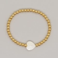 Handmade gold beaded elastic bracelet featuring a polished white mother-of-pearl heart charm - White Shell Heart