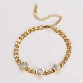 Detailed macro view of gold stainless steel bracelet with oval white turquoise stones - Howlite
