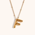 Detail of gold balloon letter F pendant on fine bead chain with polished 18K finish - Gold-F