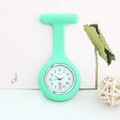 Detailed view of a green silicone nurse watch with quartz movement on a desktop - Mint Green