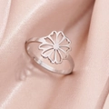 Adjustable silver stainless steel ring with hollow daisy design on pink silk background - Hollow Floral C-Steel (284 Steel Color)