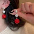 Detail of red bead drop earrings with crystal flower studs worn by a female model - Gold Double Flower Red Bead Dangle Style (HE18847)