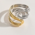 Detail of minimalist two-tone layered wrap ring featuring gold and silver wavy metal bands - Spiral Style