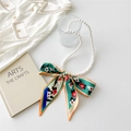 Detail of French vintage pearl necklace with a colorful floral silk scarf bow decoration - LOVE Flower Green