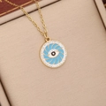 Close-up of golden evil eye necklace with blue swirl center and rhinestone bezel - Lake Blue