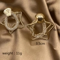 Detail view of 4cm gold star earrings with chain link texture on brown silk - Five-pointed Star