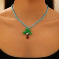 Beaded necklace with a green palm tree pendant on a light blue strand for summer - Coconut Tree (KX295)