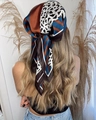 Brown and navy leopard print satin headscarf tied on wavy hair for a stylish look - Model Featured Style