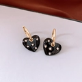 Detail of black heart drop earrings with gold hoops and sparkling rhinestone accents - Black Hoop Buckle