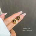 Titanium steel Roman numeral hoop earrings in gold and black finish held by hand - Gold (T305)