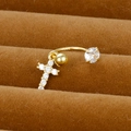 Macro shot of gold-plated curved barbell belly ring with a zircon-encrusted cross pendant - Cross Design Style (Y20370-7)