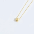 Minimalist golden horseshoe pendant necklace with polished mirror finish on cross chain - Letter U