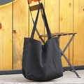 Minimalist black large capacity canvas tote bag hanging on a chair against wooden wall - Black