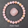 Detail of natural pink opal beaded bracelet and polished stone on black background - Pink Opal