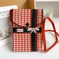 Detail of knitted houndstooth phone bag with bow decoration and adjustable shoulder strap - Bow Houndstooth Black