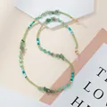 Detail of beaded eyewear chain with green stones, golden accents and silicone loops - Green