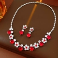 Close-up of zircon flower jewelry set with red ruby-style stones on brown leather base - Red (Two-piece Set)