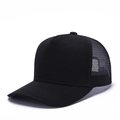 Detail shot of black trucker hat featuring breathable mesh panels and curved sun visor - Black