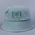 Detailed macro view of light blue denim bucket hat with green embroidery and frayed edges - M(56-58cm) / Light Blue
