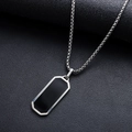 Close-up of a silver chain necklace with a black rectangular pendant on leather texture - Necklace-Black Rectangle Pendant (L490-A)