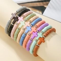 Detail of colorful Heishi clay bead bracelets with cross charms on a display stand - SY0939-1