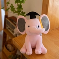 Pink plush elephant toy with graduation cap and scroll on wooden shelf - Graduation Pink/With Graduation Cap & Diploma