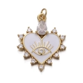 Detail of gold heart pendant with white enamel evil eye and sparkling zircon stones - White Stone Heart Eye