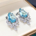 Elegant pear-cut light blue gemstone cluster earrings with sparkling zircon accents - Blue