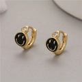 Chic gold hoop earrings with black smiley face charms and sparkling zircon accents - Black