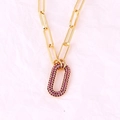 Macro detail of a gold-plated link necklace with a purple rhinestone oval pendant - Oval Rose Red Zirconia Necklace
