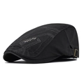 Detail view of cotton flat cap with gray stitching and metal Sports emblem on the side - Adjustable / Dark Gray