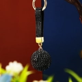 Detail of a luxury black rhinestone ball keychain with a matching strap and gold-tone metal - Single OPP Bag Packaging / Black