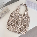 Detail view of heart-shaped leopard print canvas tote bag with woven sozakka label - Corduroy Leopard Heart Beige