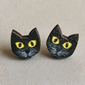 Detailed close-up of handmade wooden black cat stud earrings with bright yellow eyes - Black Cat